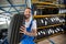 Smiling auto mechanic carrying tire