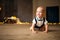 Smiling baby boy crawls against background of garland of glowing light bulbs