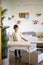 Smiling baby boy playing at cozy childish playroom interior with paper sheet rainbow arch drawing