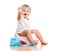 Smiling baby on chamber pot with toilet paper roll