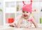 Smiling baby child crawling on nursery floor