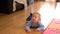 Smiling baby crawl on tummy on kitchen floor