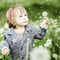 Smiling baby girl with dandelion on grass