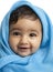 Smiling Baby Girl Draped in Blue Blanket