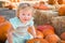 Smiling Baby Girl Having Fun in a Rustic Ranch Setting at the Pumpkin Patch