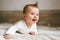 Smiling baby infant crawling at home adorable child