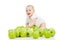 Smiling baby and many green apples