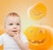 Smiling baby over pumpkins background