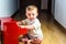 Smiling baby playing a toy piano while learning music