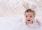 Smiling baby in rabbit costume