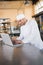 Smiling baker using laptop on worktop