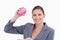 Smiling bank clerk with piggy bank in her hand