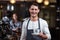 Smiling barista holding cappuccino