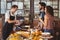 Smiling barista taking credit card from hipsters