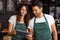 Smiling baristas using tablet