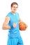 A smiling basketball player holding a ball and gesturing