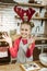 Smiling beaming woman wearing red dress and striped apron