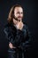 smiling bearded man biker in leather jacket with long hair, punk style