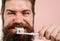 Smiling bearded man brushing teeth. Tooth paste. Tooth brush. Dental hygiene. Oral care. Closeup.