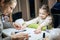 Smiling beautician doing child manicure