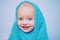 Smiling beautiful baby bathing under a shower at home. Little baby washing with a bubbles in bath in a hat. Happy bath