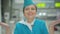 Smiling beautiful Caucasian stewardess sending air kiss at camera. Portrait of charming mid-adult woman posing in