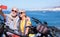 Smiling beautiful elderly couple sitting on the cliff taking a selfie with smartphone. Active retirees enjoying healthy lifestyle