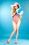 Smiling beautiful girl pin-up in a pink bikini with beach ball