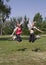 Smiling beautiful and handsome girls jump happy.Sports in park.