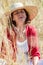 Smiling beautiful older woman enjoying sun in high dry summer field