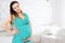 Smiling beautiful pregnant woman at home with big belly. Pregnancy and motherhood concept. Happy baby expectation. Interior