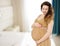 Smiling beautiful pregnant woman at home with big belly. Pregnancy and motherhood concept. Happy baby expectation. Interior space