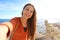 Smiling beautiful tourist woman taking selfie photo in Alicante, Spain. Traveler girl taking self portrait on Santa Barbara castle