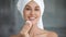 Smiling beautiful woman hold cotton pad cleansing face skin