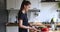 Smiling beautiful woman preparing healthy food in kitchen.