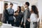 Smiling beautiful woman shaking male hand, greeting handshake of female applicant arriving at job interview, businesswoman making