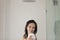 Smiling beautiful woman taking shower, standing in bathroom