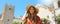 Smiling beautiful woman in Taormina main square. Tourist girl visiting Italian landmark on Sicily Island. Panoramic banner view