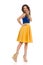 Smiling Beautiful Woman In Wedge Shoes And Yellow Dress Is Holding Hand On Chin And Looking Away