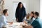 Smiling biracial businesswoman lead meeting with employees