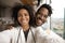 Smiling biracial couple make selfie at home together