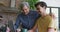 Smiling biracial man with arm around young son using laptop at home