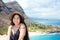 Smiling biracial teen girl with Hawaiian mountain and beach back