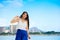 Smiling biracial teen girl walking along beach in Honolulu, Hawaii