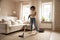 Smiling biracial woman cleaning carpet using vacuum cleaner