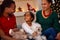 Smiling Black family with presents at Christmas