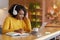 Smiling black girl with headset studying online, using laptop