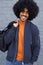 Smiling black guy with afro holding bag