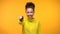 Smiling black lady pointing finger in camera, choosing winner, yellow background