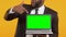 Smiling black manager pointing finger into laptop with green screen, job offer